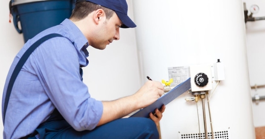 Photo of a technician inspecting a water heater
